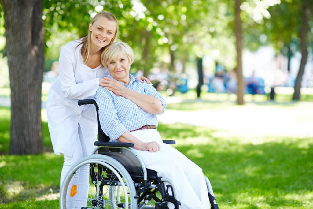 A woman in a wheelchair accompanied by an older woman, sharing a special moment together.